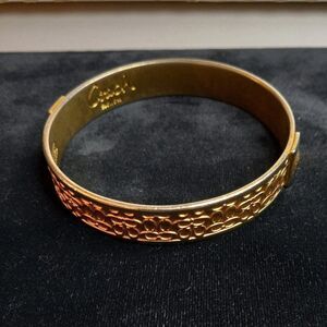 Coach Signature gold tone metal bracelet
